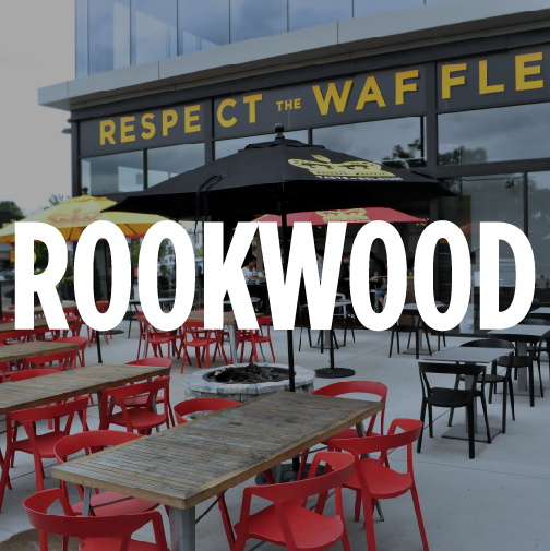 the storefront of taste of belgium's location in rookwood in cincinnati, ohio. The word "ROOKWOOD" is overlaid in bold white letters